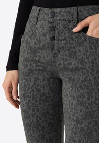 Gray patterned pants with a speckled design, featuring a high waistband, three button closure, and side pockets. Textured fabric.