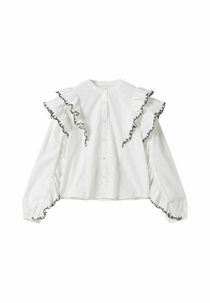 Witte blouse met lange mouwen en ruches op de schouders en manchetten, afgezet met zwarte borduursels, met knopen aan de voorkant en een ronde halslijn.