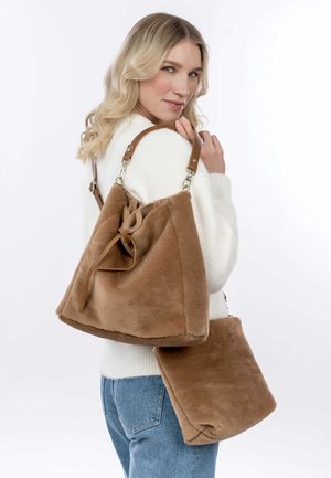 Brown faux fur bucket bag with a drawstring closure and leather straps, paired with a smaller matching pouch. Smooth texture and soft appearance.