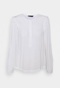 Blusa bianca a maniche lunghe con scollo tondo, chiusura frontale con bottoni, volant sulle spalle e vestibilità morbida. Tessuto liscio.