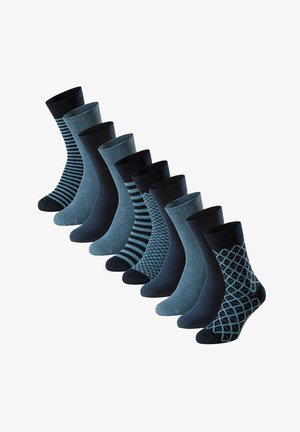 Nine pairs of men's crew socks in alternating solid navy and blue with striped, diamond, and geometric patterns arranged in a diagonal line.