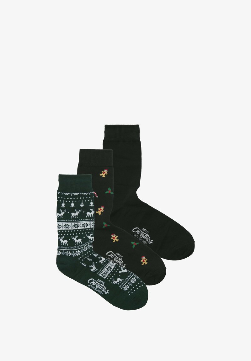 Drie paar sokken: donker groen met rendieren en sneeuwvlokken patroon, effen donker groen, en zwart met peperkoekmannetjes en hulst accenten.