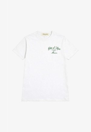 T-shirt blanc à manches courtes avec texte vert sur la poitrine gauche indiquant "Côte d'Azur Racquet Club Monaco" et col rond.