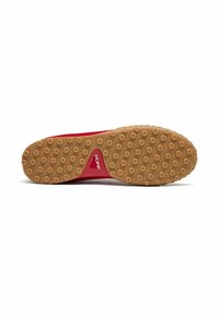 Suela de zapato deportivo roja con una superficie de goma natural decorada con un patrón de puntos de tracción circulares. Incluye la marca "HOFF" en rojo.