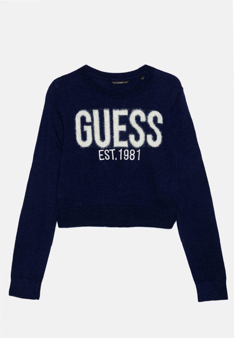 Pull court bleu marine à manches longues avec le texte duveteux blanc "GUESS" et "EST. 1981" en dessous sur le devant.