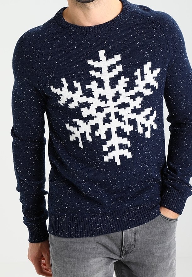 Navy knit sweater with white snowflake pattern, featuring a textured, speckled design and ribbed cuffs and hem.