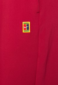 Nike Performance HERITAGE PANT - Calças de fato de treino - pomegranate