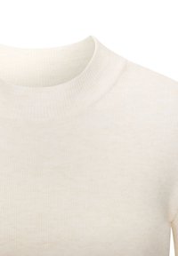 Šviesiai rudas, ribuotas megztas golfas su glaudžia silueto forma. Minkšta tekstūra ir subtilūs spalvų pokyčiai audinyje.