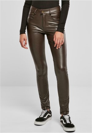 Bruine neplederen broek met een aansluitend ontwerp, vijf pocket-stijl en een subtiele glans. Gecombineerd met zwart-witte lage sneakers.