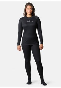 Black long-sleeve top and fitted leggings made from ribbed fabric, featuring a subtle mountain design on the chest.