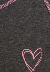 Dark gray fabric features a smooth texture with a pink heart graphic design. The neckline showcases a contrasting pink stitching detail.
