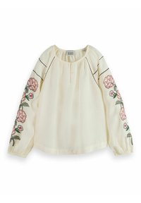 Cream blouse with long sleeves, gathered cuffs, and embroidered pink floral designs on sleeves. Button neckline detail and soft, textured fabric.