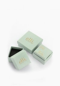 To kvadratiske mintgrønne kasser lavet af papir, med et gyldent "elli" logo og en struktureret sort indvendig, hvoraf den ene er delvist åben.