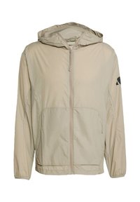 Light beige hooded jacket, made of smooth, lightweight material. Features a front zipper, two front pockets, and a black logo accent.