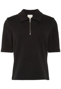 Polo noir à manches courtes avec col plié et fermeture éclair mi-longue à l'avant, affichant un logo discret Calvin Klein sur la poitrine.