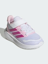 Pelēkas un rozā sporta kurpes ar tīkliņa augšdaļu, baltu zolīti un Velcro aizdari. Tām ir trīs violetas svītras un reljefas detaļas.