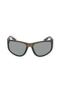 Gafas de sol con un marco de plástico oscuro y angular y lentes grises. Cuenta con brazos curvados y un acabado brillante.