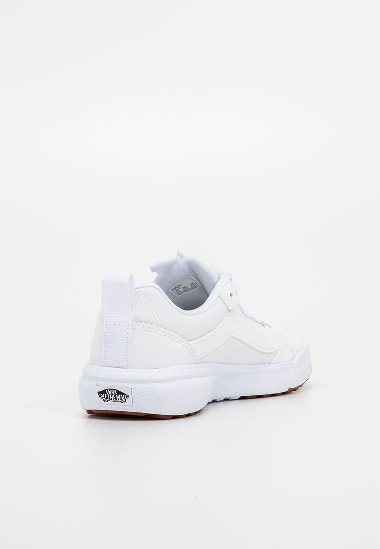 Zapatilla blanca con parte superior sintética suave, cuello acolchado y suela de goma. Presenta una etiqueta con el logo en el talón y un diseño texturizado en los laterales.