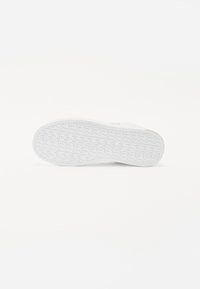 White rubber shoe sole with a textured tread pattern, rounded shape, and smooth edges. Features a simple and clean design.