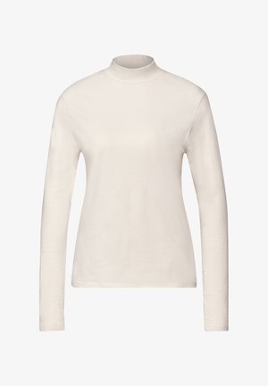Haut à col roulé long à manches, en crème, fabriqué en coton doux, avec une silhouette ajustée et une texture lisse, sans motifs ni embellissements.