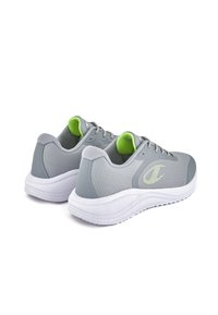 Gray athletic shoes with mesh upper, green accents, and white rubber sole. Features a textured pattern and minimalistic logo on the side.