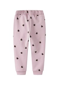 Pantalones de chándal rosa con cinturilla elástica y puños acanalados, con un estampado de pequeños corazones negros en toda su superficie. Material de algodón suave.