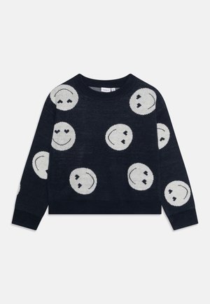 Granatowy sweter z białymi uśmiechniętymi buźkami, niektóre z oczami w kształcie serca, rozrzucone na przodzie i rękawach.