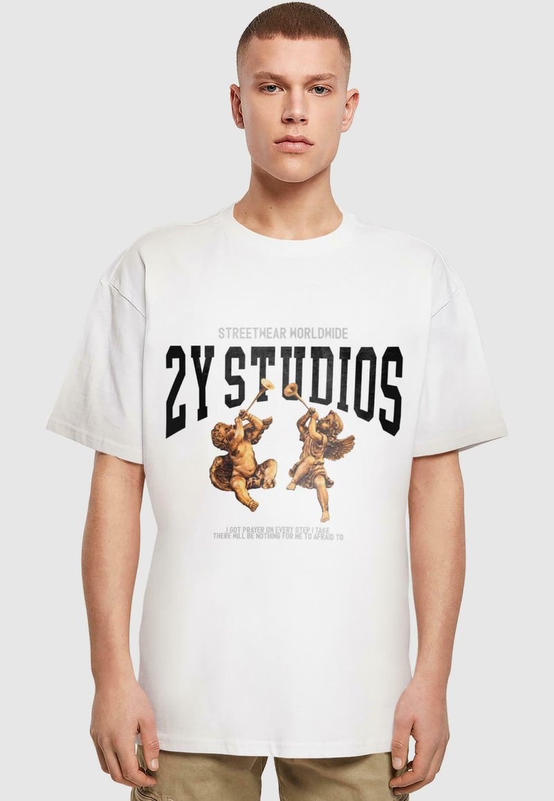 Bílý bavlněný tričko s grafickým designem dvou cherubínů, černý text s nápisem "2Y STUDIOS" a citátem níže, volný střih.