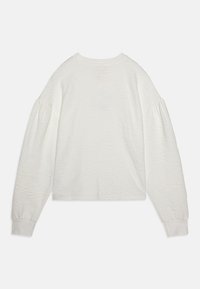 White long-sleeve top with a textured floral pattern, rounded neckline, and slightly puffed sleeves. Soft fabric and cropped design.