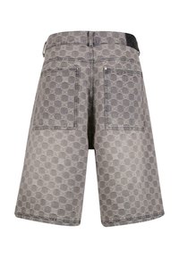 Graue Denim-Shorts mit einem kreisförmigen, geprägten Muster, gesteppten Details und zwei Gesäßtaschen. Ein elegantes, modernes Design.