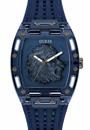Montre-bracelet en plastique transparent bleu avec un relief de lion sur le cadran, aiguilles des heures et des minutes argentées, et un bracelet en caoutchouc texturé bleu.