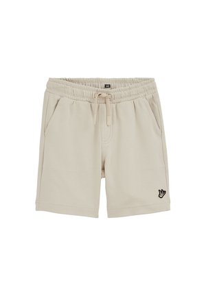 Short beige avec taille élastique, cordon de serrage, poches latérales et petit logo oiseau noir et blanc sur la jambe gauche.
