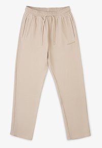 Beiga, ribbade tygbyxor med elastisk midja, dragsko, två sidofickor och en guldlogotyp i nederkanten till vänster.