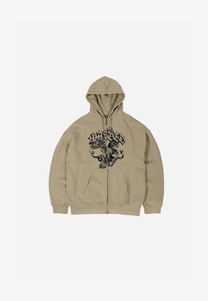 Bežinė zip-up sukapota palaidinė su juodu erelio grafiku, kengūrinėmis kišenėmis ir virvute ant gobtuvo. Minkšta medžiaga, laisvas siluetas.