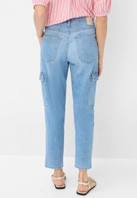 Hemelsblauwe denim cargobroek met twee zijzakken, twee achterzakken, rechte snit en zichtbare stikseldetails.