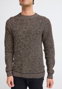 Brown knit sweater with a textured pattern, crew neck, and long sleeves. Features ribbed cuffs and hem, made from a soft, flexible material.