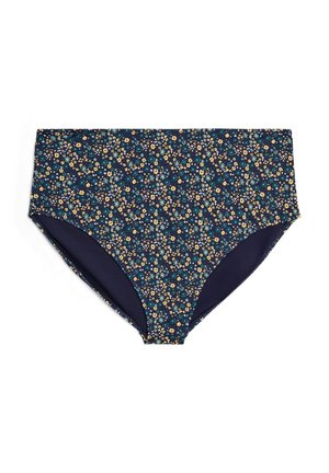 Augsta vidukļa bikini apakšdaļa ar tumši zilu pamatu un maziem dzelteniem, zaļiem un baltiem ziedu rakstiem, attēlota guļus uz baltas virsmas.