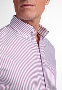 Button-up shirt in light purple with thin white stripes. Features a structured collar, single pocket, and textured fabric.