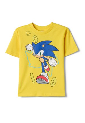 Chemise jaune à manches courtes avec un dessin d'un hérisson bleu de dessin animé en train de courir et des anneaux dorés dispersés à l'avant.