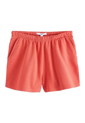 Lachsfarbene, legere Shorts mit elastischem Bund, Seitentaschen und Größenschild mit der Aufschrift "Next S" auf weißem Hintergrund.