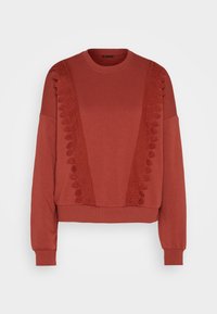 Červená mikina s krajkovou vsadkou na ramenou a vpředu, žebrovanými manžetami a lemem a kulatým výstřihem. Měkký materiál.