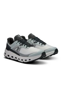 Sport shoes featuring a gray and white mesh upper, black accents, padded collar, and distinctive sole with horizontal openings.