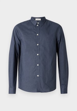 Navy blue long-sleeve button-up shirt made from smooth fabric; features a classic collar, white buttons, and a curved hemline.