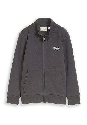 Veste zippée gris foncé avec deux poches avant, poignets et ourlet côtelés, et un petit patch en forme de skateboard sur la poitrine.