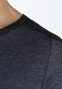 Navy blue short-sleeve shirt with a black ribbed neckline, featuring a textured knit pattern and subtle embroidered branding on the shoulder.