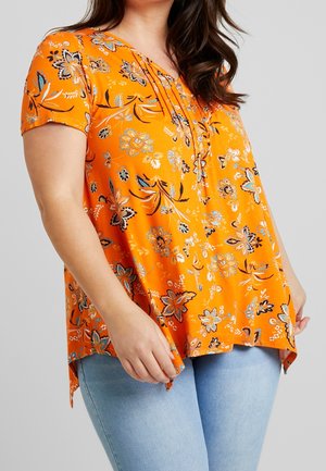 Orange floral blouse with short sleeves, v-neck, and subtle pleats. Features black and blue floral patterns. Hem is slightly longer at the sides.