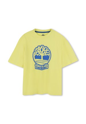 T-shirt in cotone giallo con vestibilità rilassata. Presenta un logo di un albero blu e un design circolare con il testo "TIMBERLAND Est. 1973" nella parte inferiore.