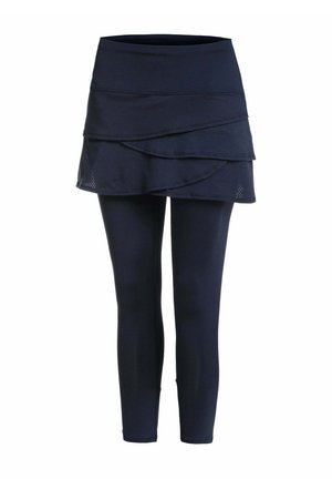 Leggings bleu marine avec une jupe superposée attachée présentant un design style cache-cœur sur fond blanc.
