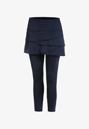 Marineblauwe leggings met een aangehechte gelaagde rok met een wikkelstijl ontwerp op een witte achtergrond.