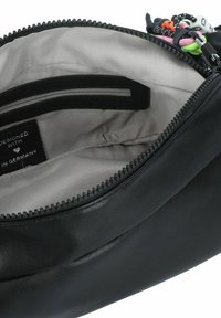 Black leather pouch with textured exterior, zipper closure, and gray interior lining. Features an inner zip pocket and tags.